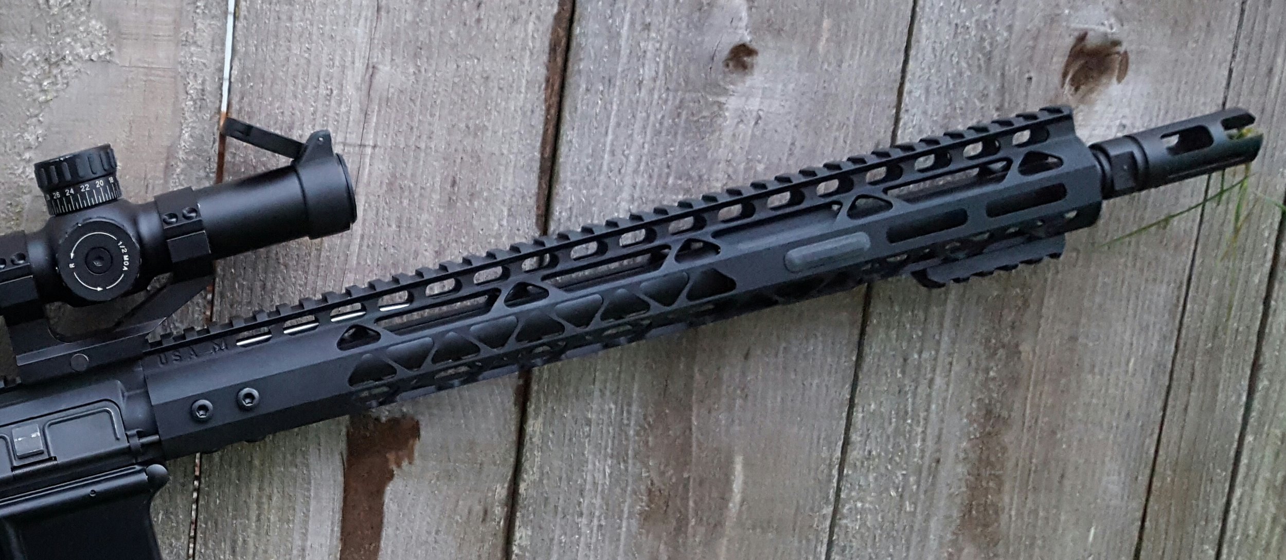 Shown with an extra M-Lok rail on bottom and a rubber M-Lok cover