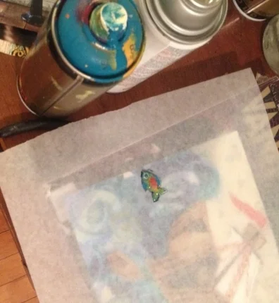 Splashes of spray paint tend to be a signature final touch. To add spray paint to certain areas, Emily uses tracing paper to cover the rest to the piece.