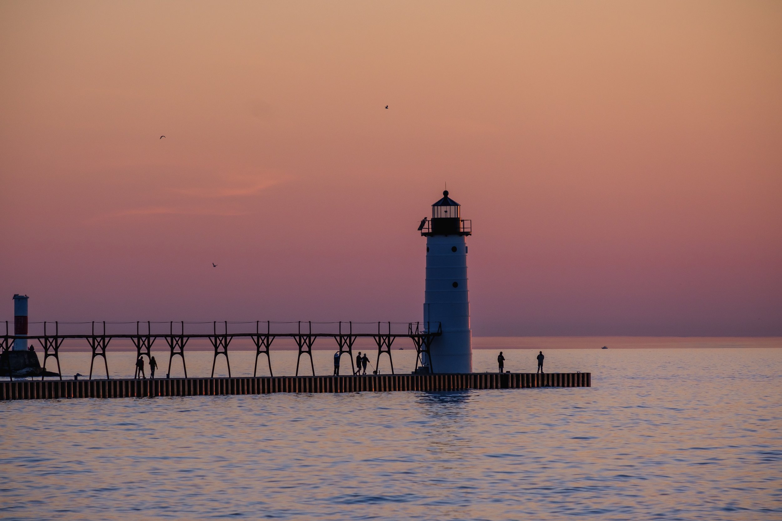  A lighthouse watches the sunset over Lake Michigan. 