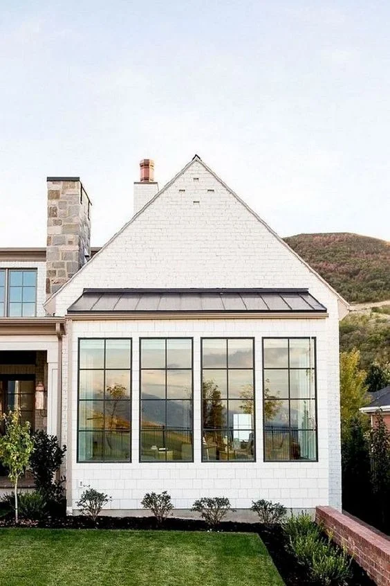 love these simple windows in the front - thinking of switching out our large window and replacing with 3 more slender ones like these. 