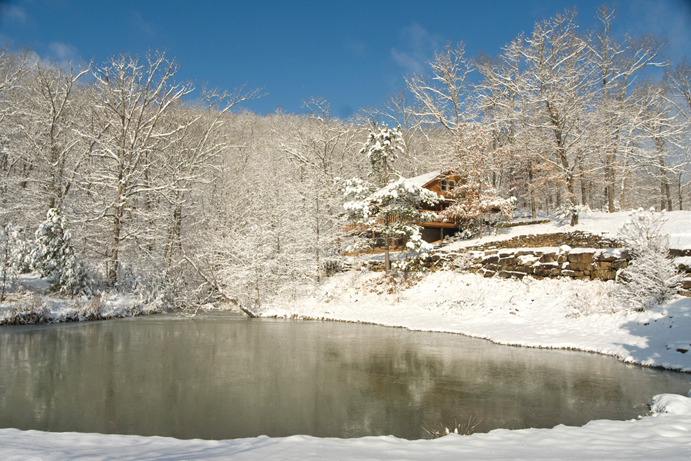 Cabin and pond in winter