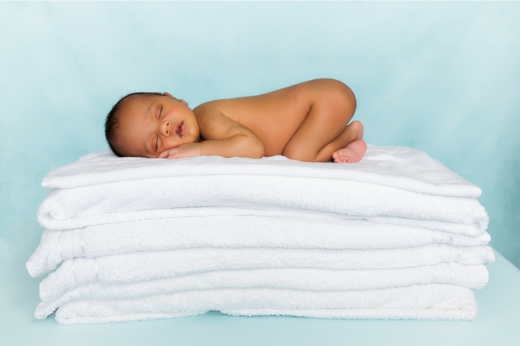 baby laying on towels.png