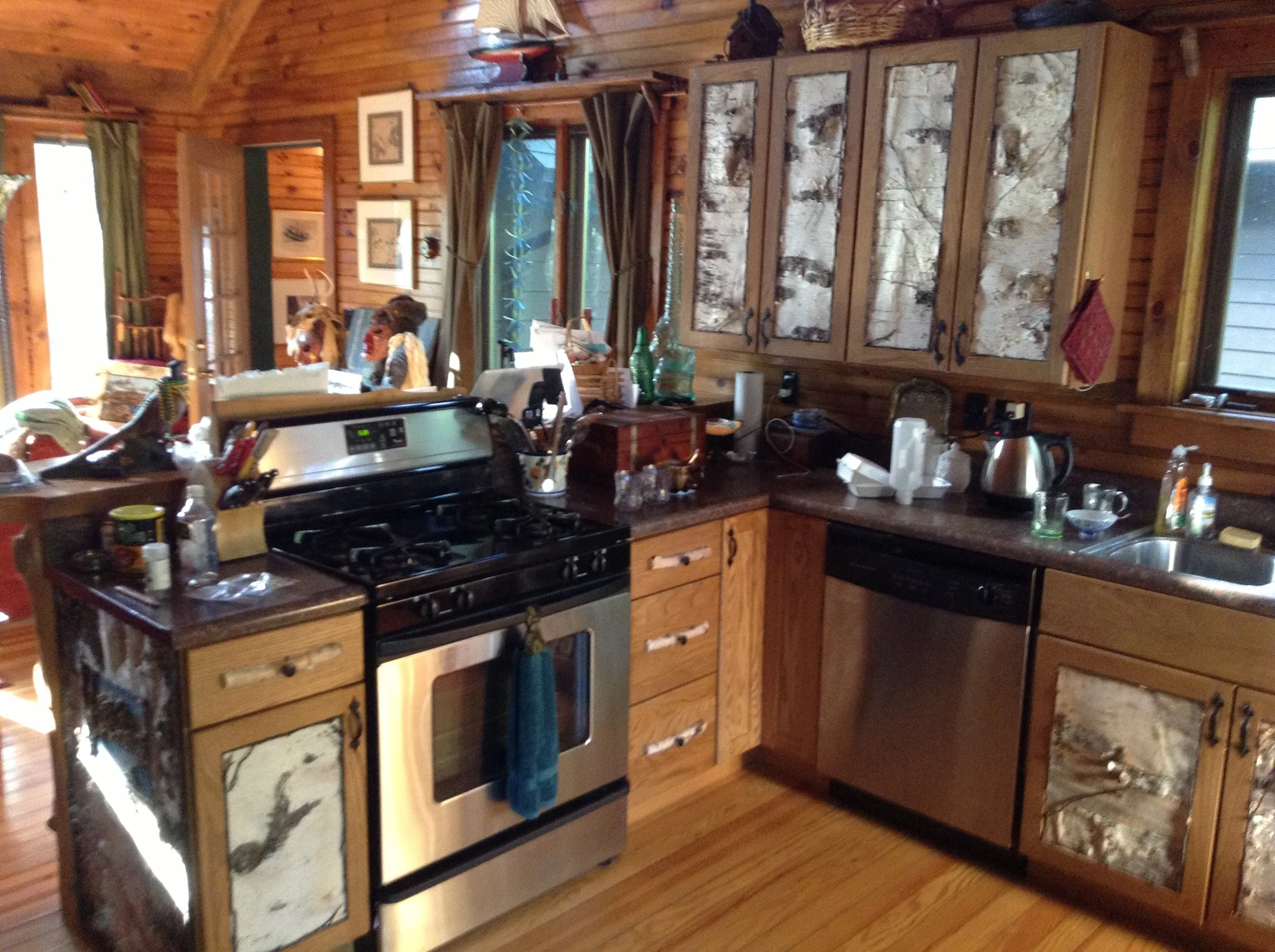 Cabinet doors with bark insets and twig accents done by Anne