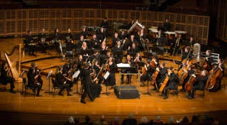 SSO Fellows and members of the Sydney Conservatorium Symphony Orchestra, directed by Roger Benedict, preparing to perform Werner Baer’s The Test of Strength . © 2017 The University of Sydney. Photograph by David Goldman.
