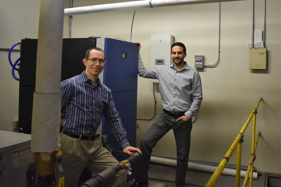 Dan Nadav (left) and Mike Cocuzza (right) at the installation of their SmartWatt boiler beta unit in Hartford, Connecticut.