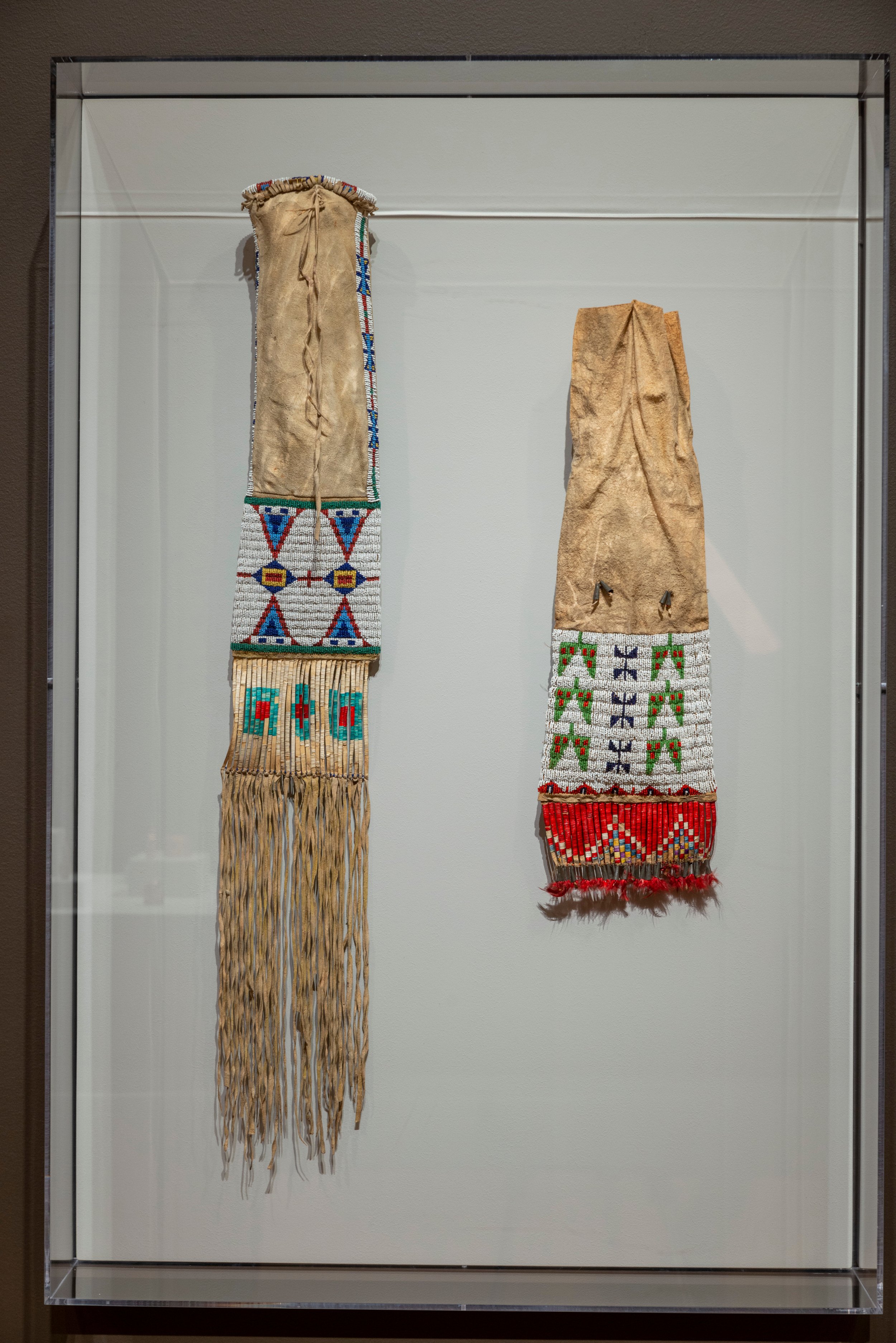  LEFT TO RIGHT  Unidentified Lakota Artist   Pipe Bag&nbsp;   Late 19th century  Hide, porcupine quills, glass beads, feathers, metal  GIFT OF MRS. RICHARD W. CASE, SPARKS, MARYLAND, BMA 1985.132     Unidentified Lakota Artist   Pipe Bag   c. 1880s D