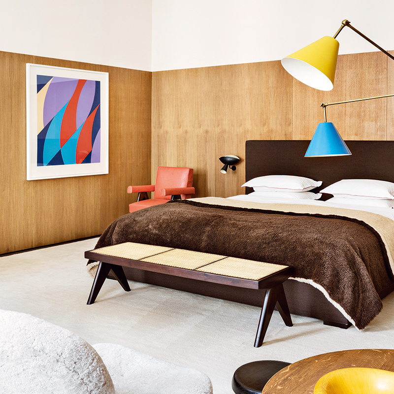 The bedroom in fashion boutique owner Emmanuel de Bayser's apartment, with Bridget Riley art on the wall. Photo: Manolo Yllera