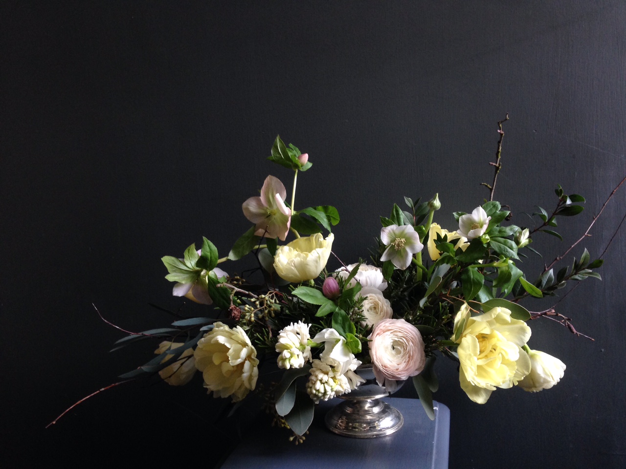 A seasonal Mother's Day arrangement including double tulips, hyacinth, ranunculus, hellebore and alder/Photo: Hedgerow Florist