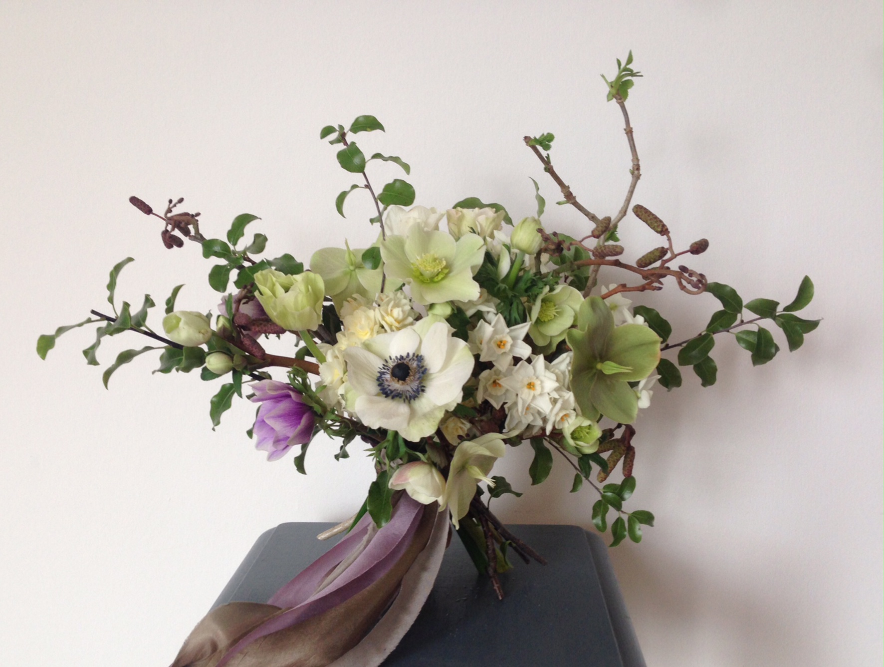 This British-grown bouquet includes anemone, hellebore, alder and paperwhite narcissi