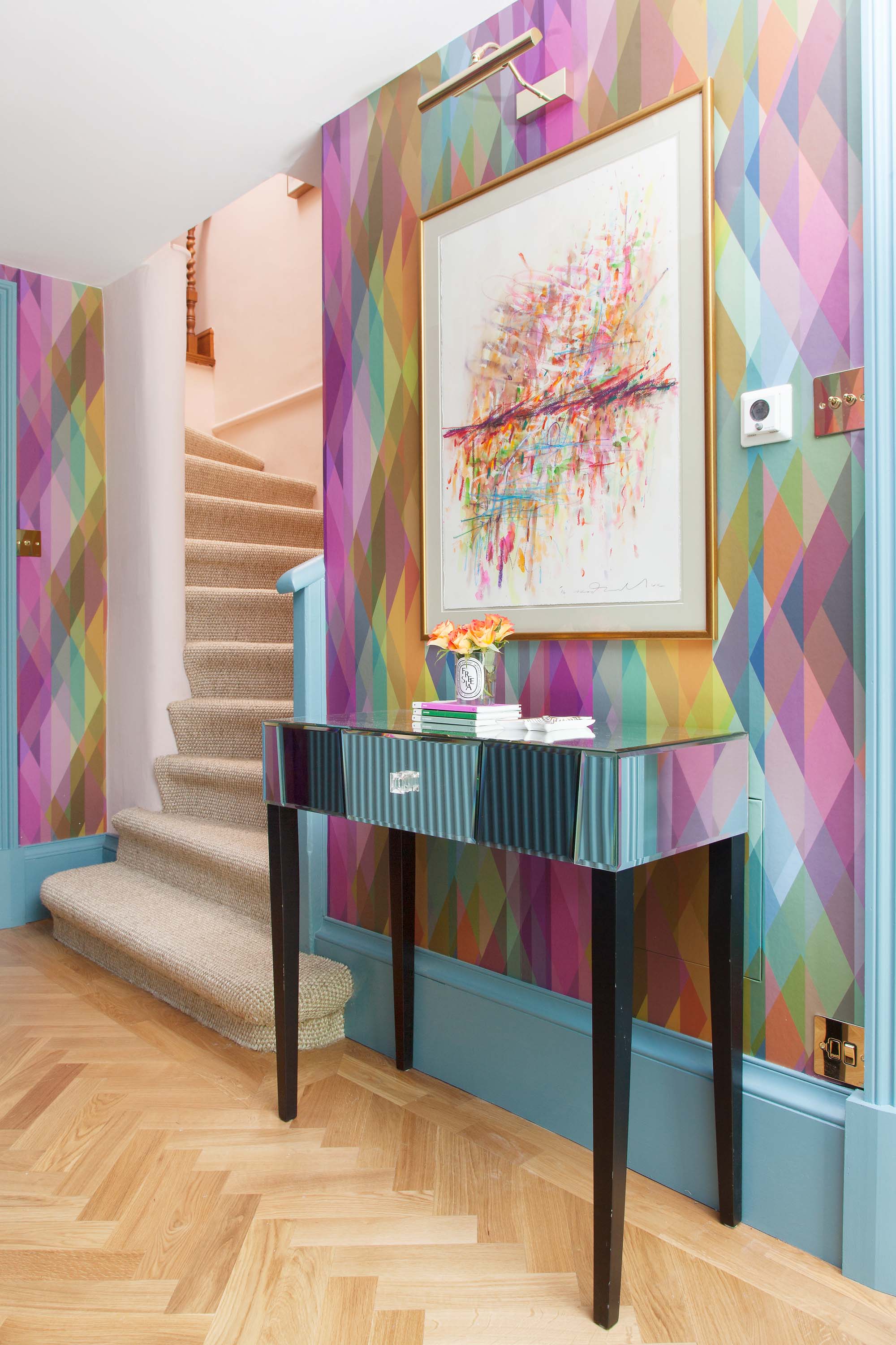 The Pink House basement hallway with Cole & Son Prism wallpaper