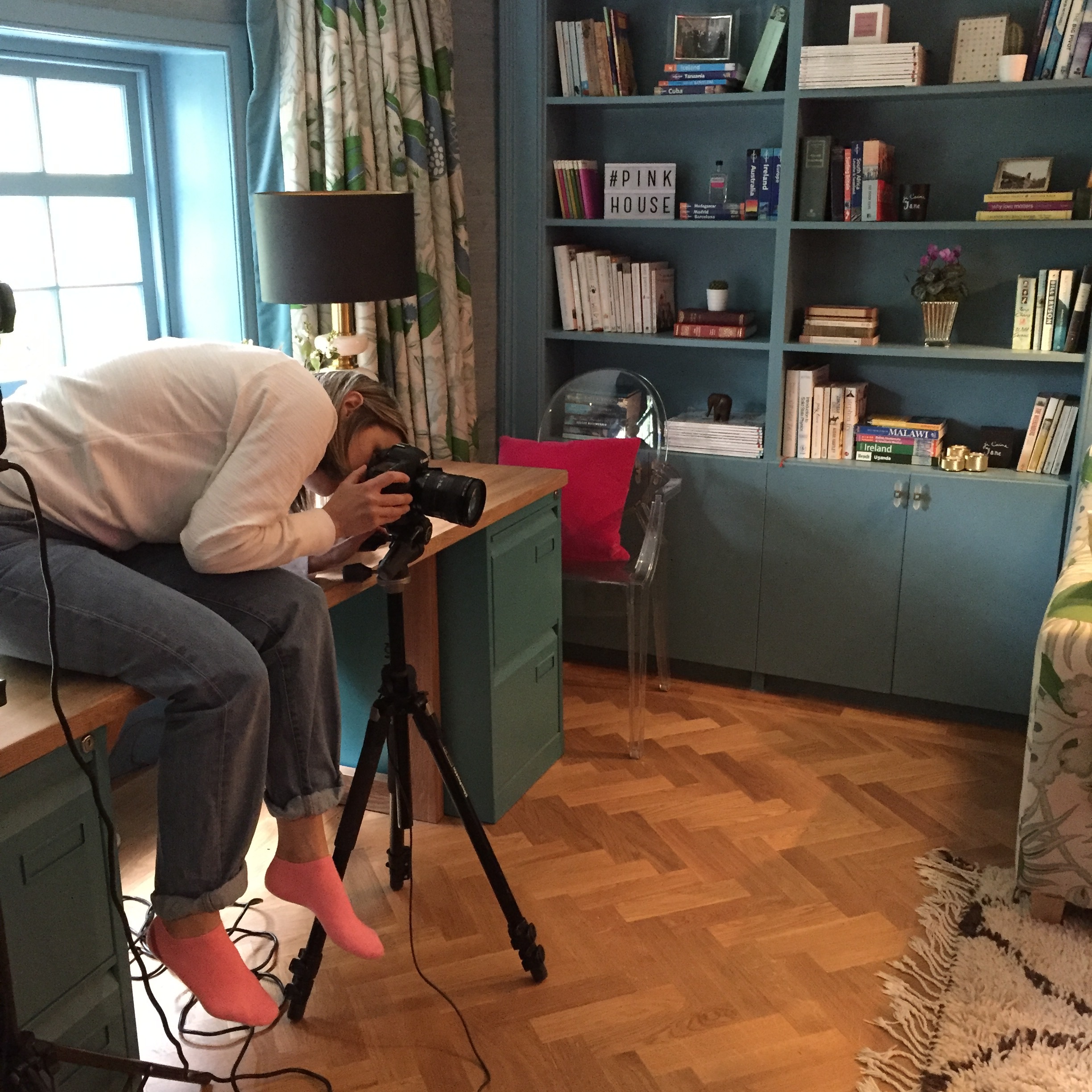 Susie snapping The Pink House den. Interior photographers always match their socks to the cushions