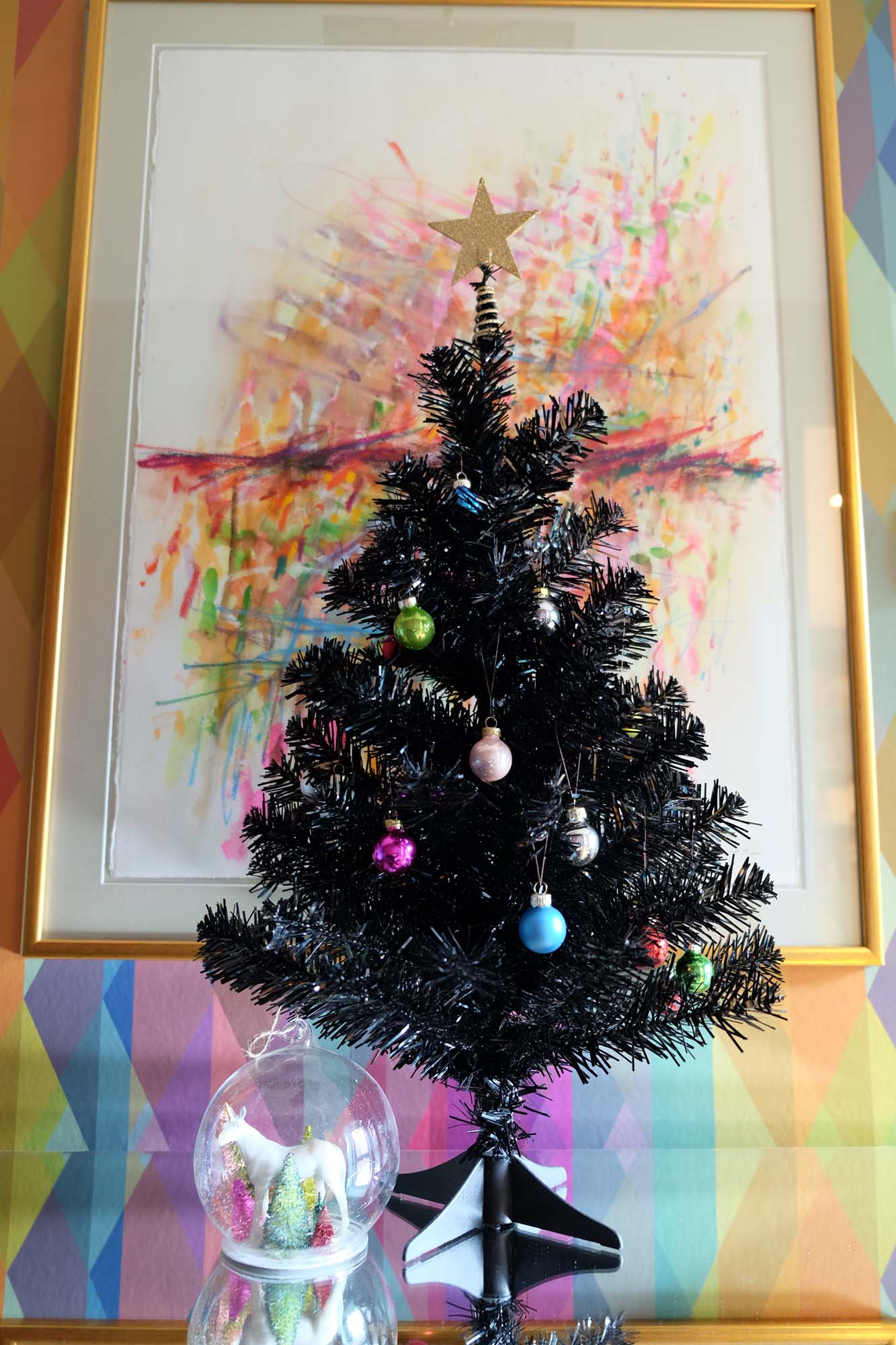 Unicorn bauble and multi-coloured baubles on tree: Rockett St George/Wallpaper: Cole &amp; Son Prism/Painting: Dale vN Marshall