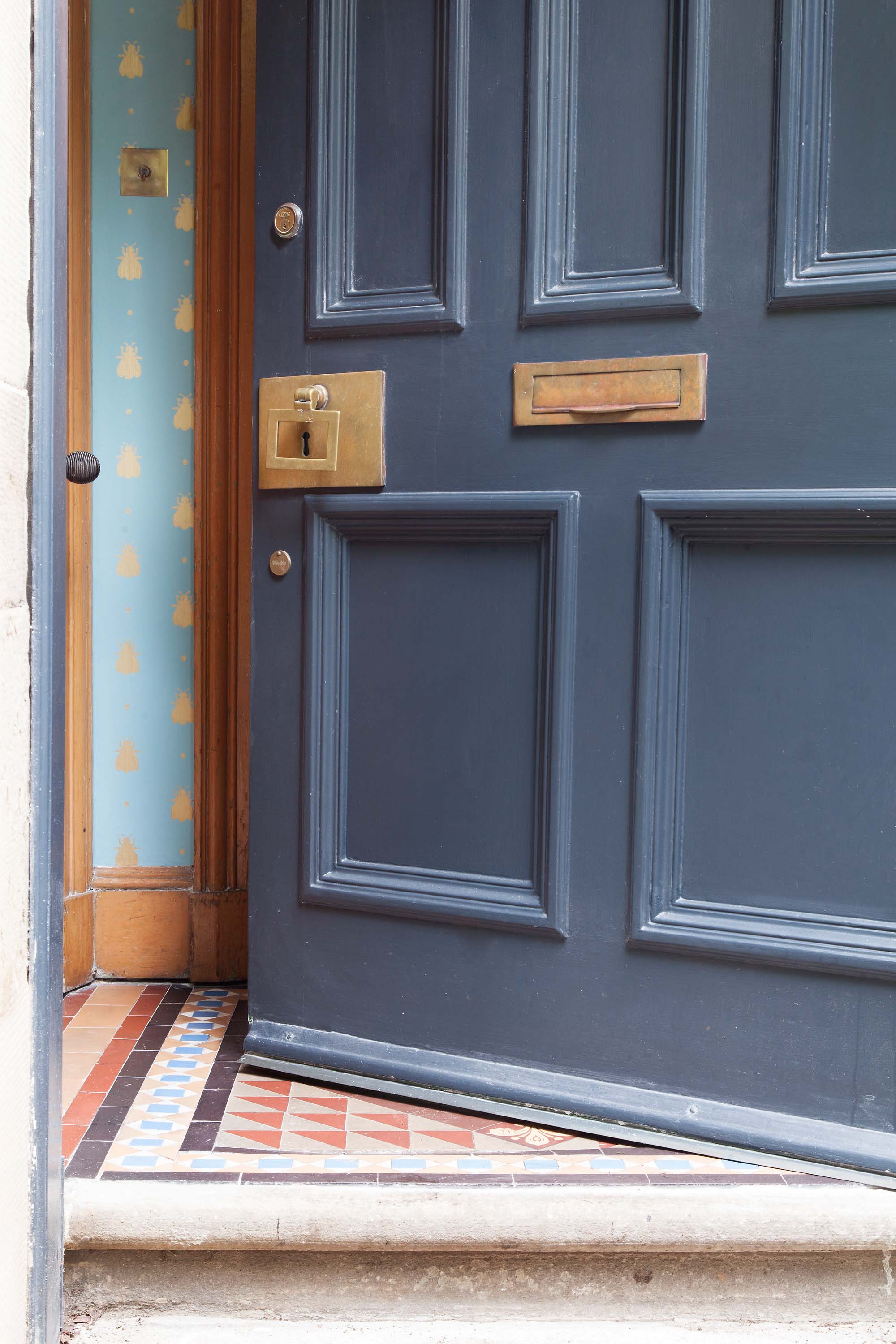 Farrow & Ball Railings front door with Bumblebee wallpaper