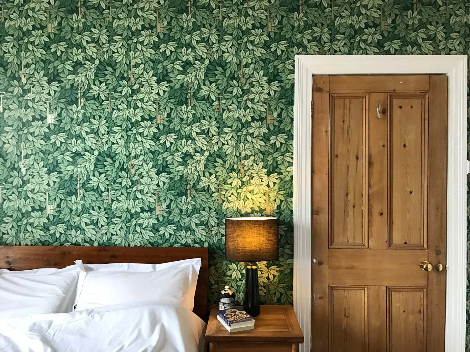 Fornasetti gold keys wallpaper in a bedroom