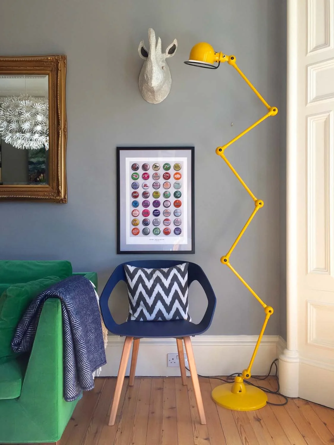 Go Pop The Collection print, Tom Love; Yellow lamp, Jielde; Rhino head, Anthropologie; Sofa, IKEA; Rug, Cox & Cox