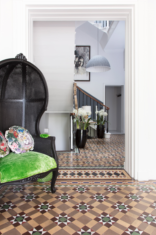 The hallway (those tiles!), with a chair Anna designed herself and sells on PAD/Photo: Susie Lowe