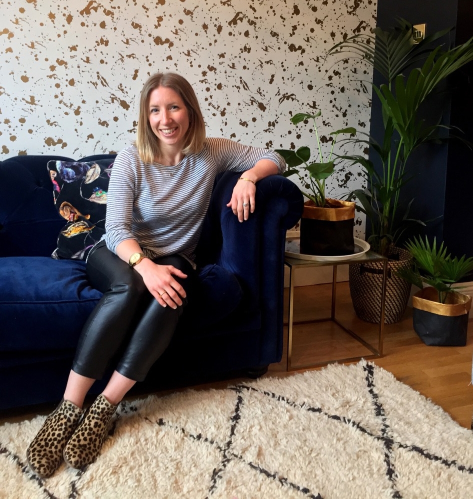 Jess with her biggest decor triumph: Jonathan Adler gold Drip wallpaper