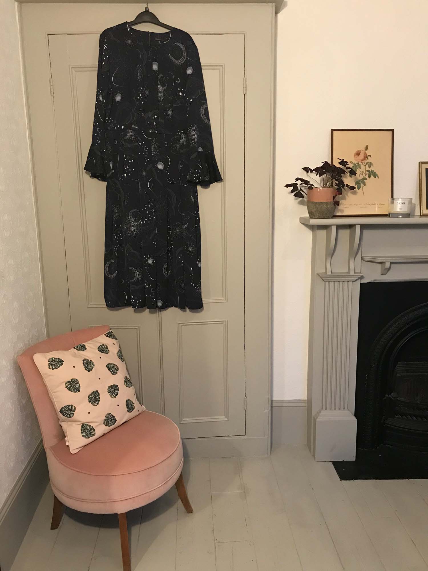 A corner of Clemmie and Simon's bedroom, complete with reupholstered vintage chair, and Elizabeth Scarlett cushion