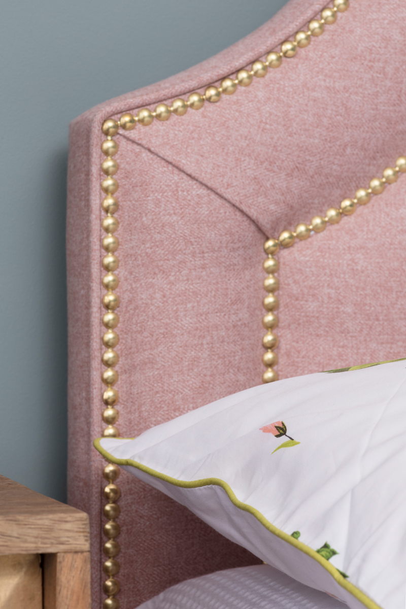 Pink and brass headboard