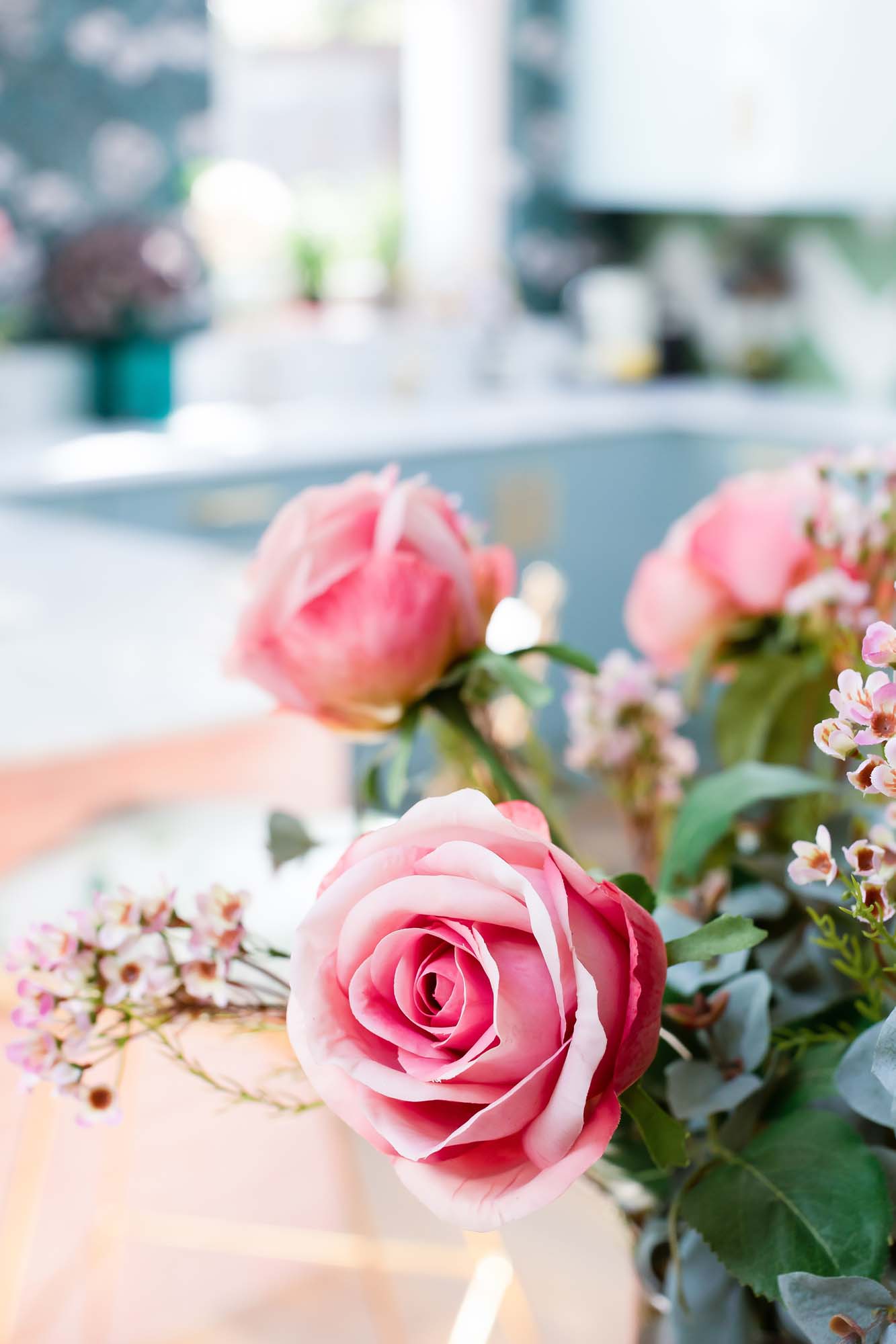Faux roses and waxflowers | Photo: Jane Looker Photography