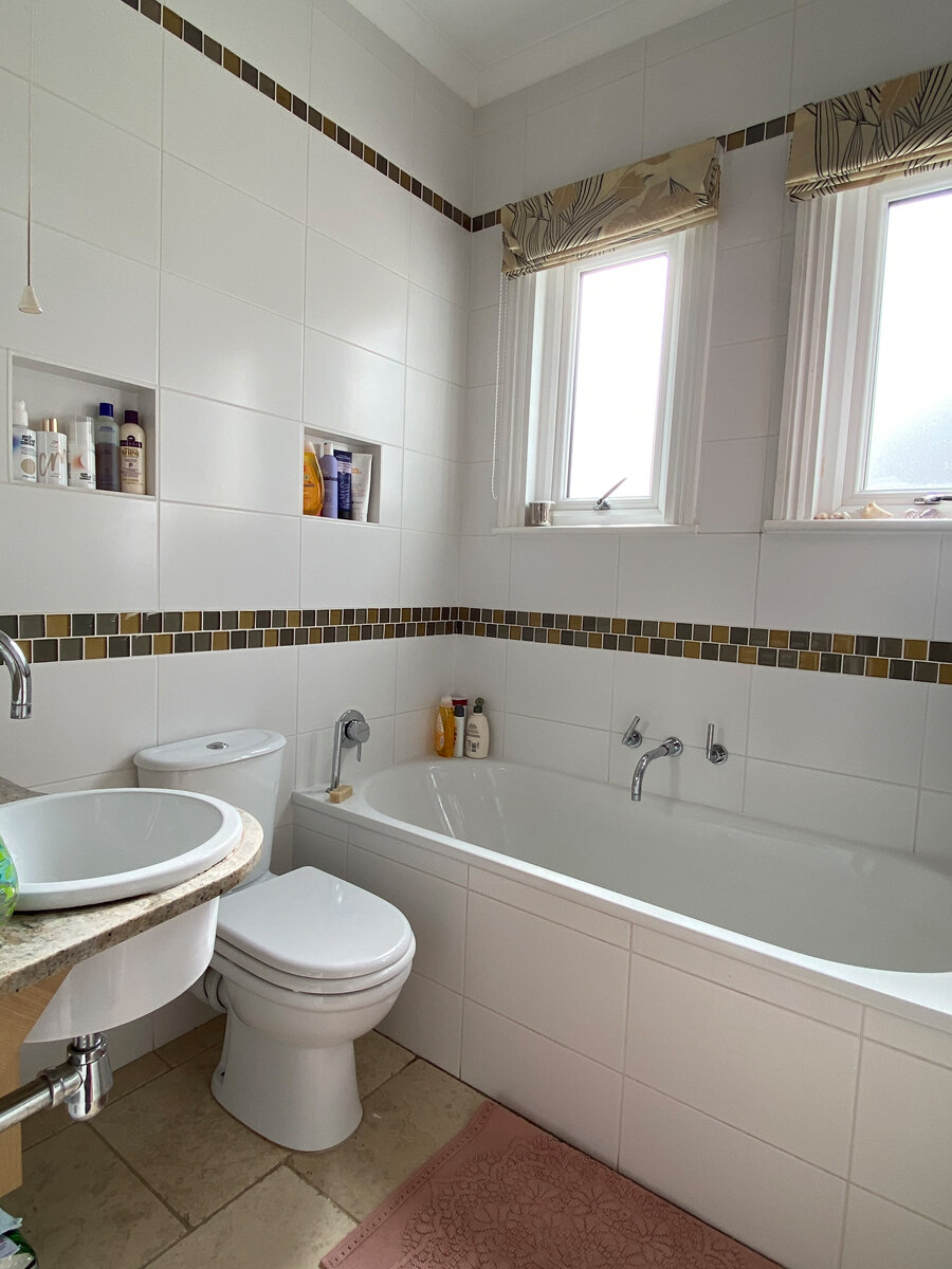 The pretty pink bath mat improves the room by 100%