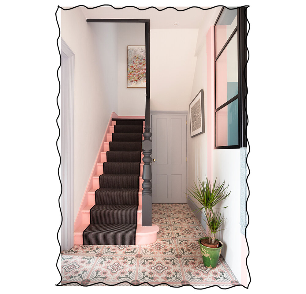 The Pink House hallway with pink stairs and black bannister