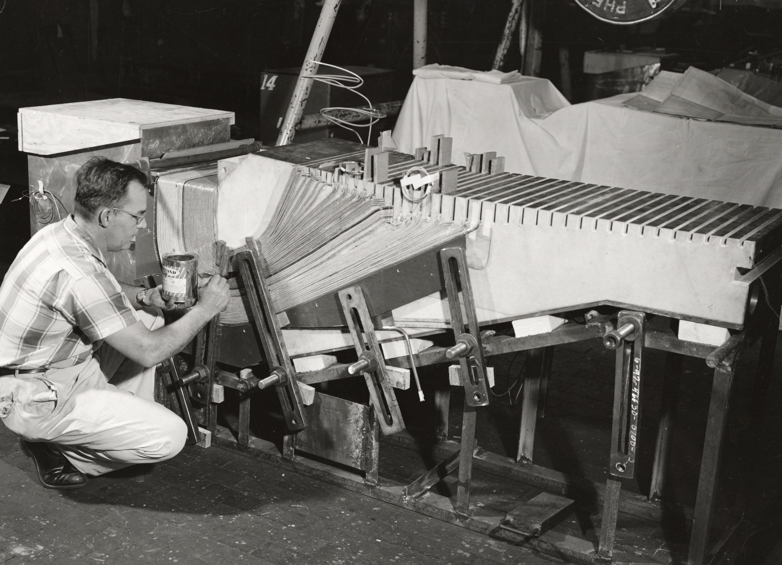   Midwestern Universities Research Association (MURA) experimental magnet core section showing application of epoxy resin to coils. October, 1959. Photo: University of Wisconsin Madison Archives  