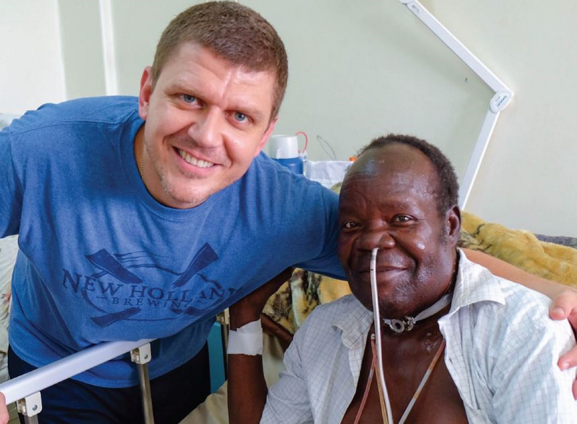 Dr. Chad Zender with headmaster David Amiye, whose total laryngectomy was performed at the Uganda Cancer Institute 