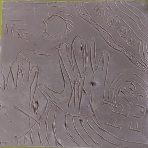 this was the youngest workshop participant's tile, her older sister helped her make some markings in the wet clay and traced her little hands. Then the sister finished the space with some of her own drawings...making it a special two-sister tile.