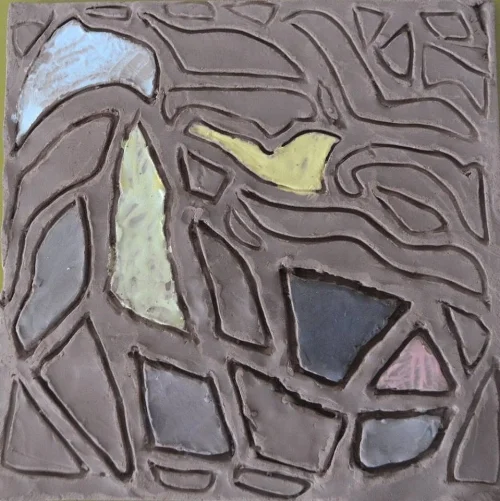 this tile was made by an older teen boy who before the workshop began, had described to me his favourite art form was making mosaics out of little pieces of glass...this is his clay/glass mosaic