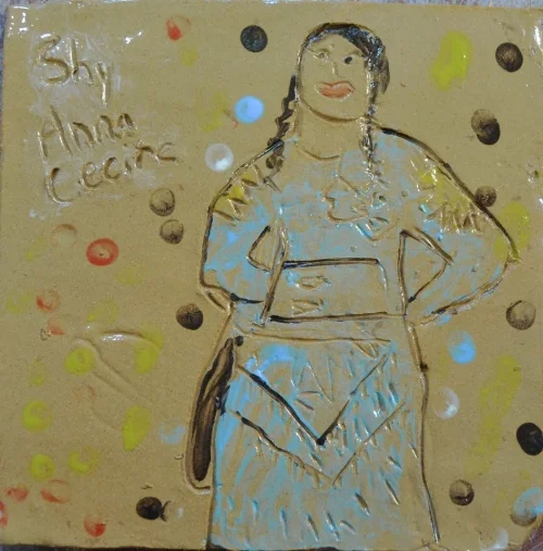 I believe this shy woman is dancing in a Jingle Dress. 