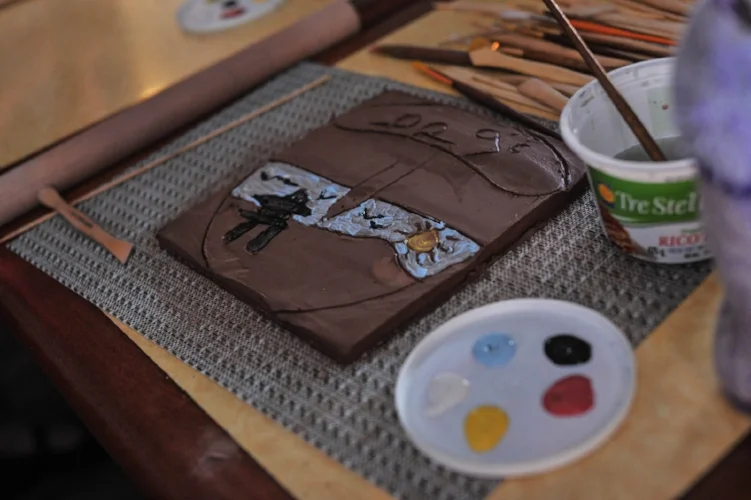 applying under-glaze paints to colour the tiles