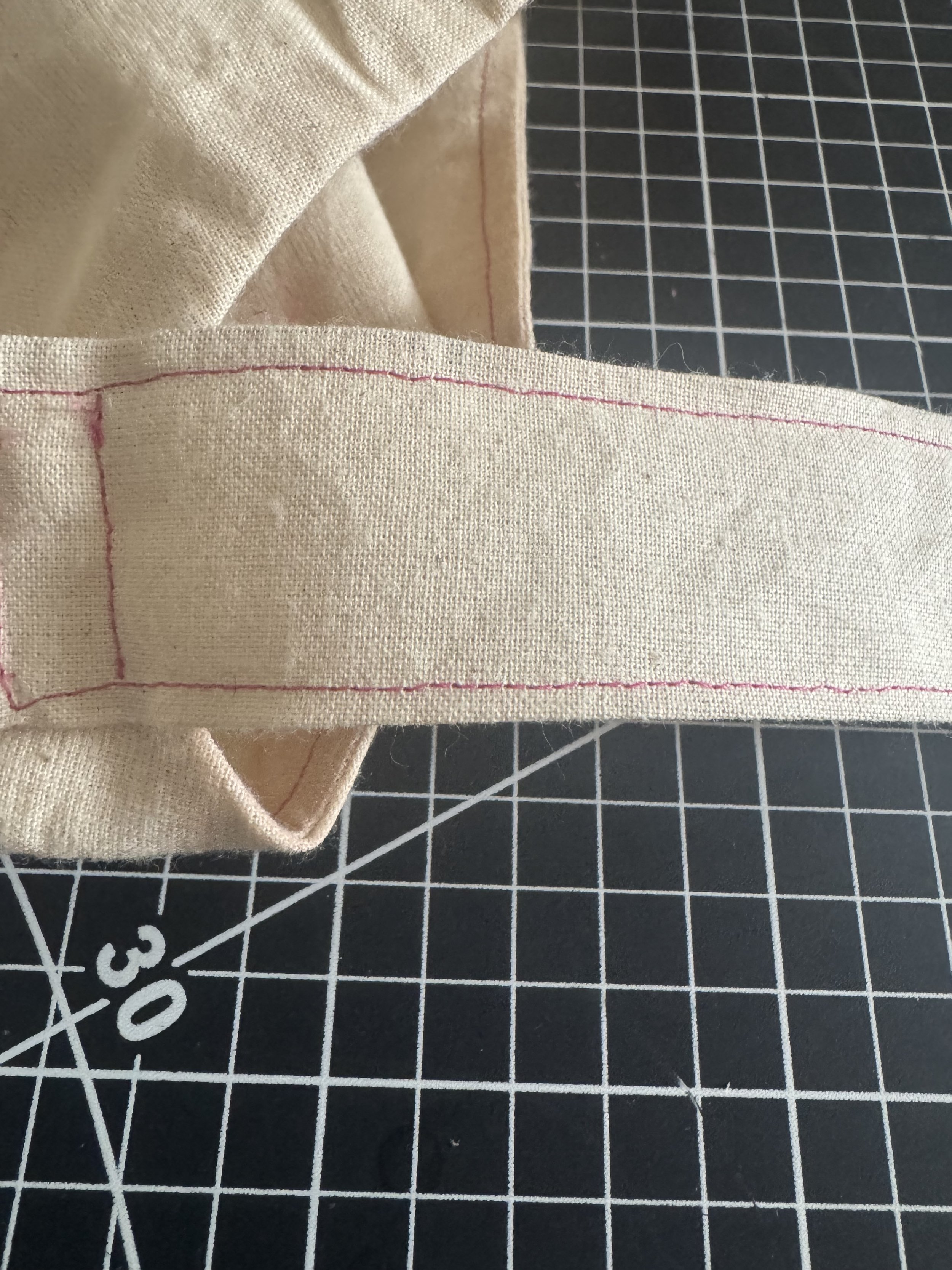  Stitch close to the edge, and flip the strap towards the sleeve. 