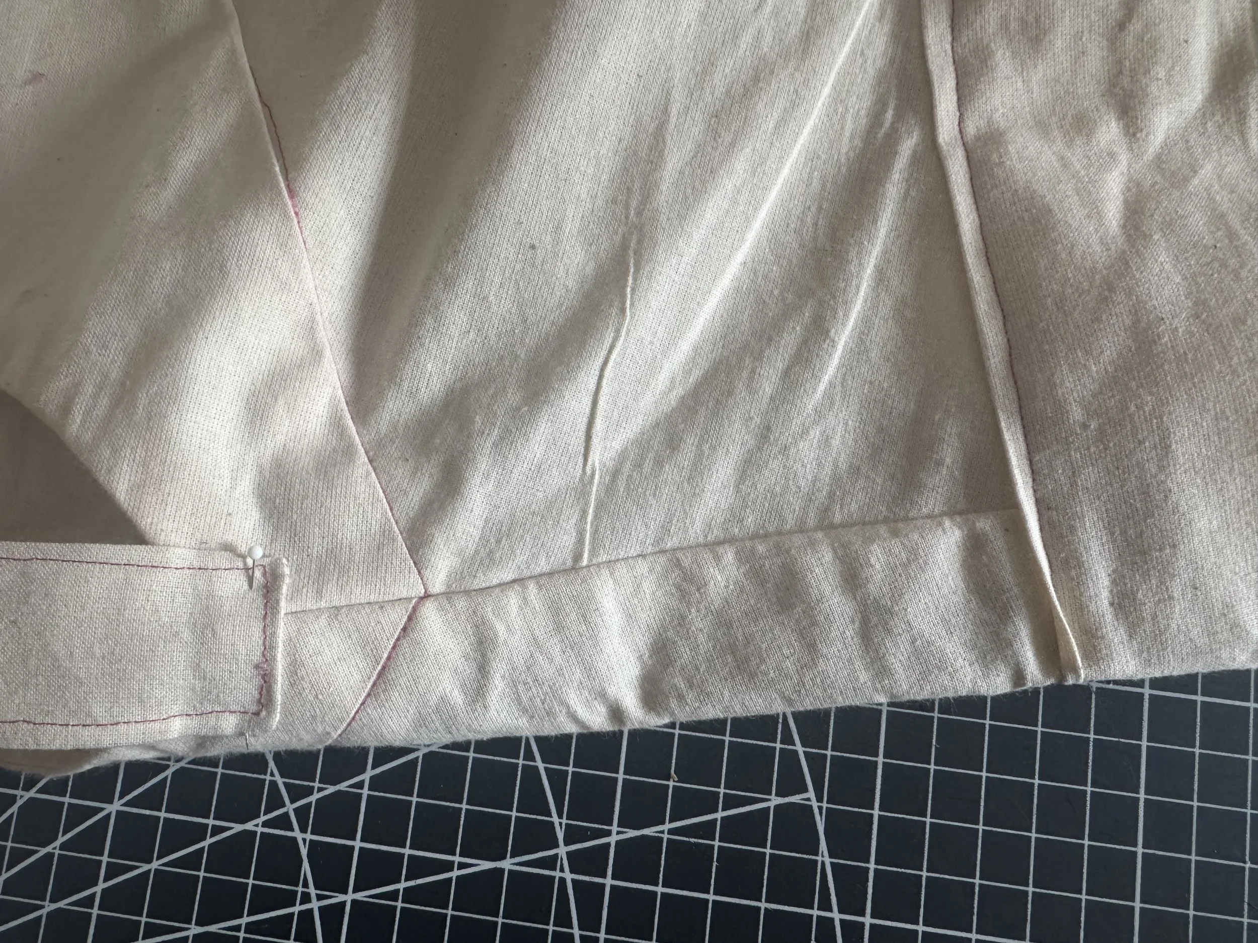  Pin the edge of the strap close to the neckline. 