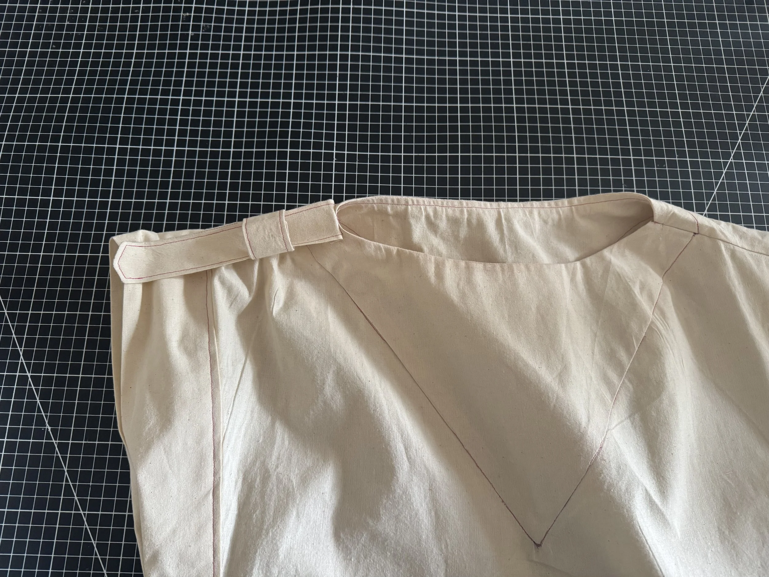  To hold the end, I sewed a small section over the top stitch as seen to the left. 