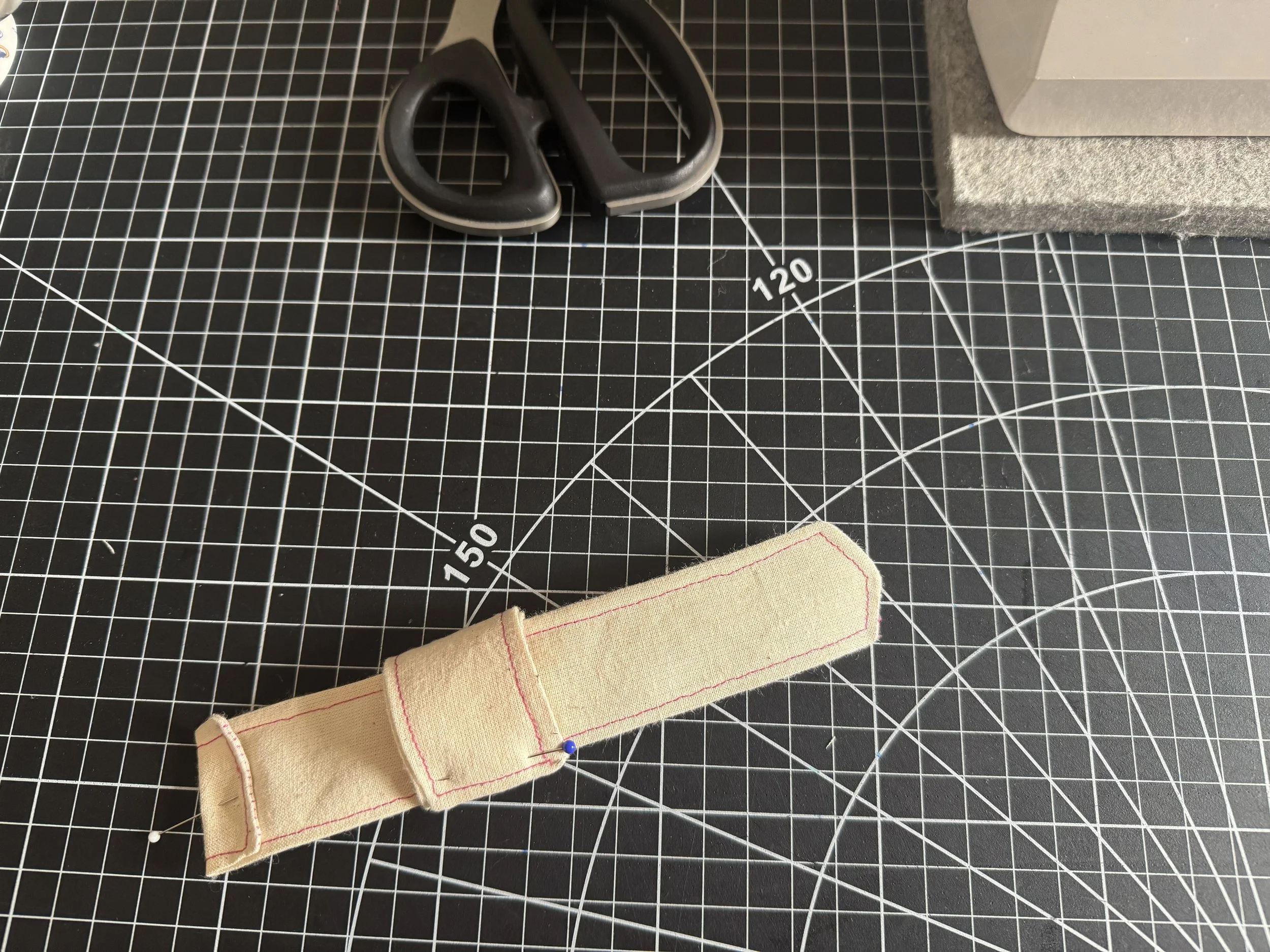  Fold your tab over your strap until it’s the same width, pin. 