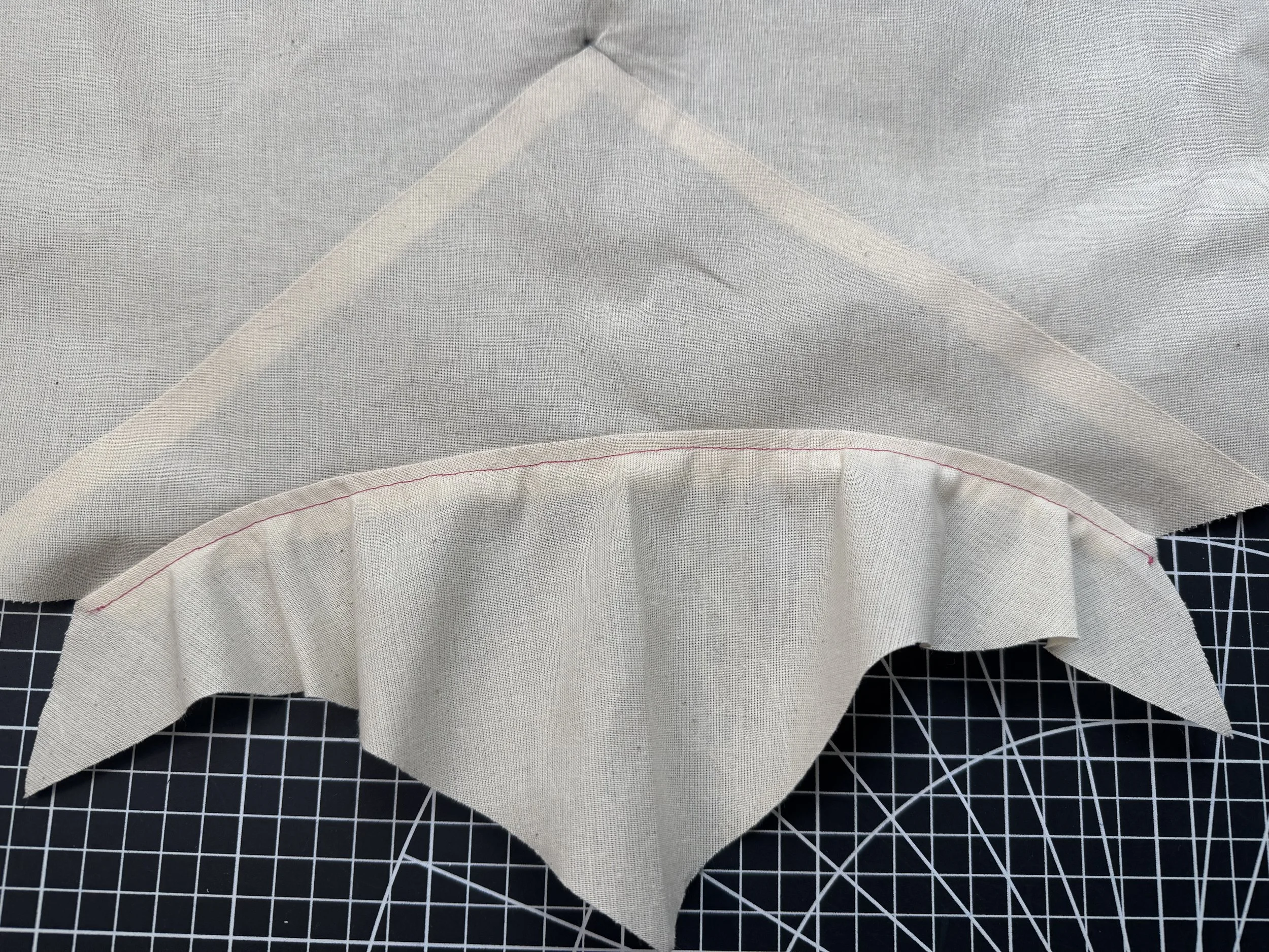  Flip your seams to the facing again, and understitch.  The neckline has a minimal curve, and snipping should not be necessary. 