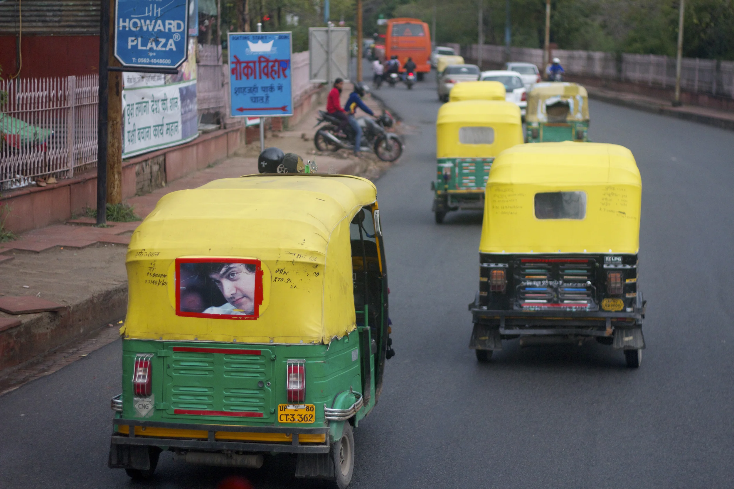 Tuk tuks drive through the streets of New Delhi, India.