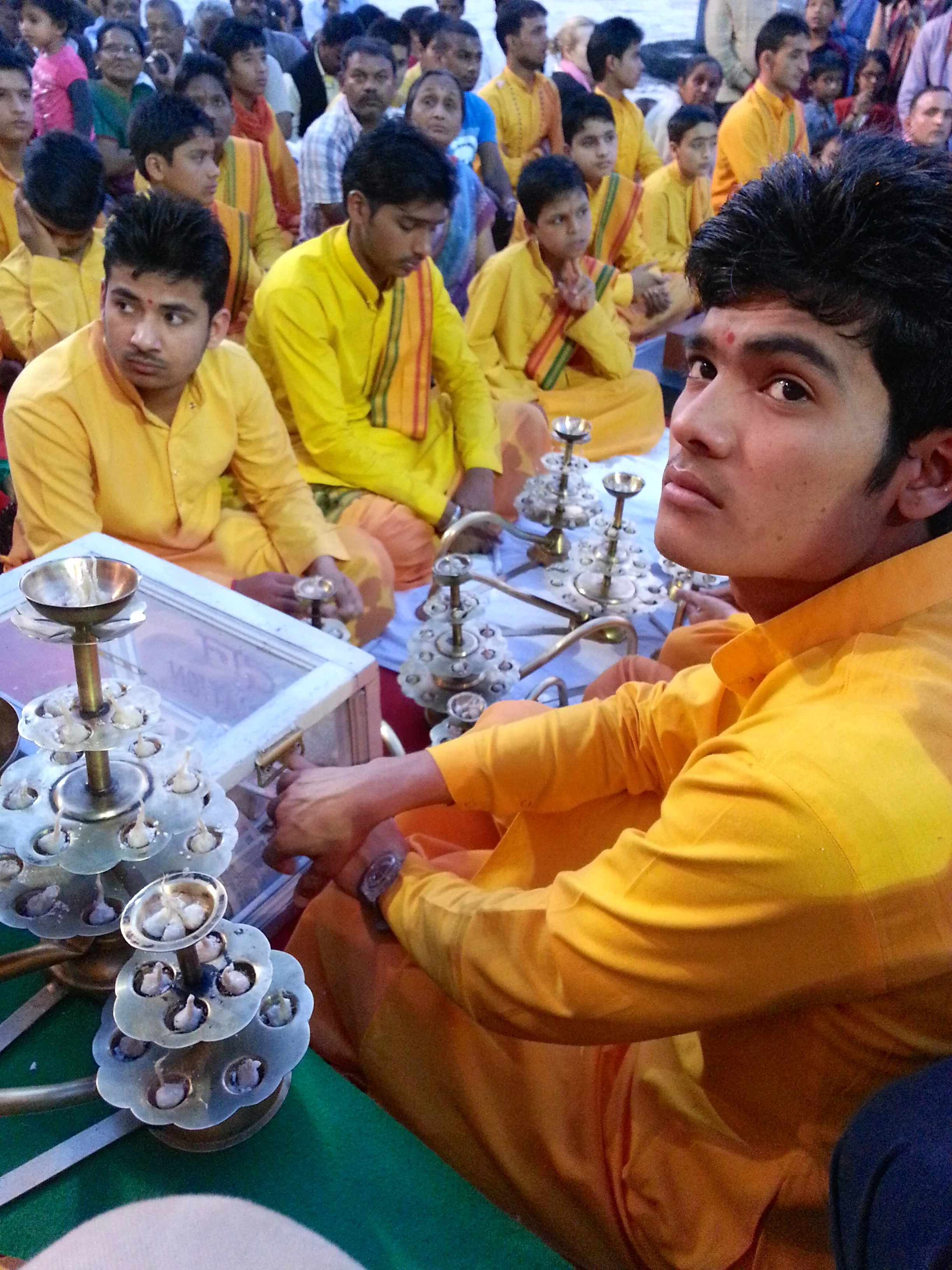 Devotees prepare the sunset aarti along the Ganges River near Rishikesh, India.