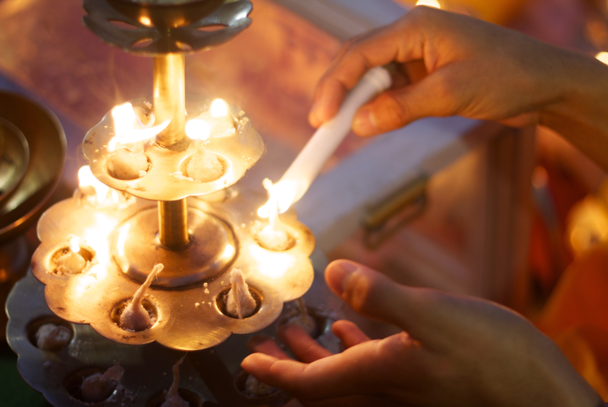 Hindu devotees light aarti lamps near Rishikesh, India.
