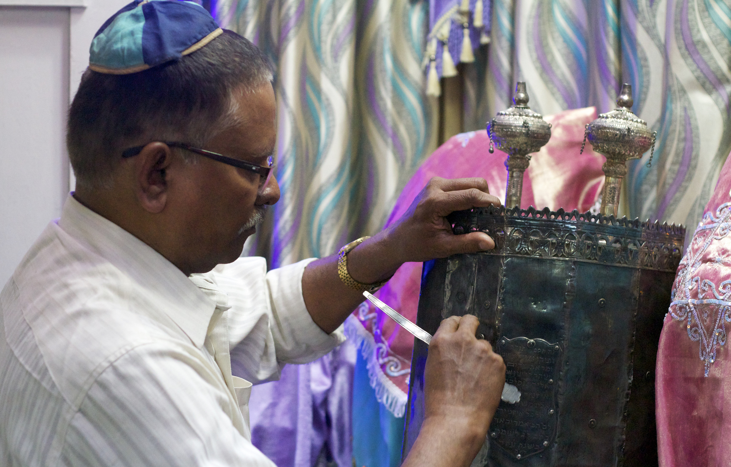 A man secures the Torah in the Magen Abraham Synagogue in Ahmedabad, India.