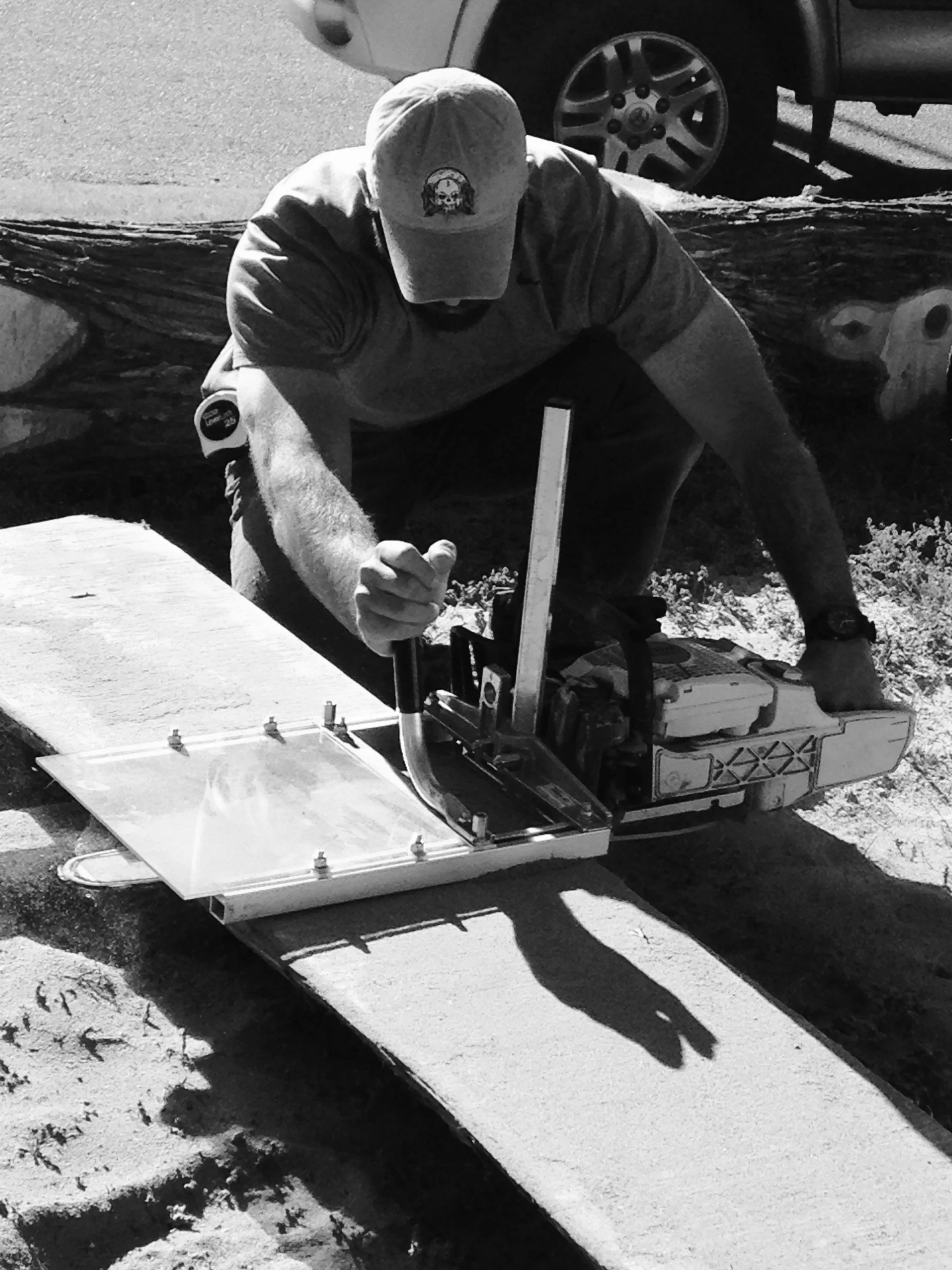 Caleb, owner of Arbor Press Interior Design & Remodeling, is in his element cutting planks out of an old Ash tree to use later in his carpentry shop.