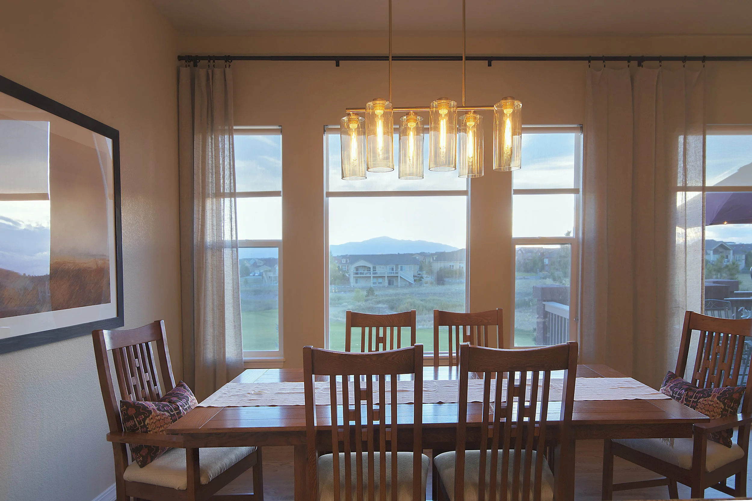 This stunning chandelier sets the stage for intimate dinners as this light and the pendant lights were placed on dimmer switches. Check out that view!