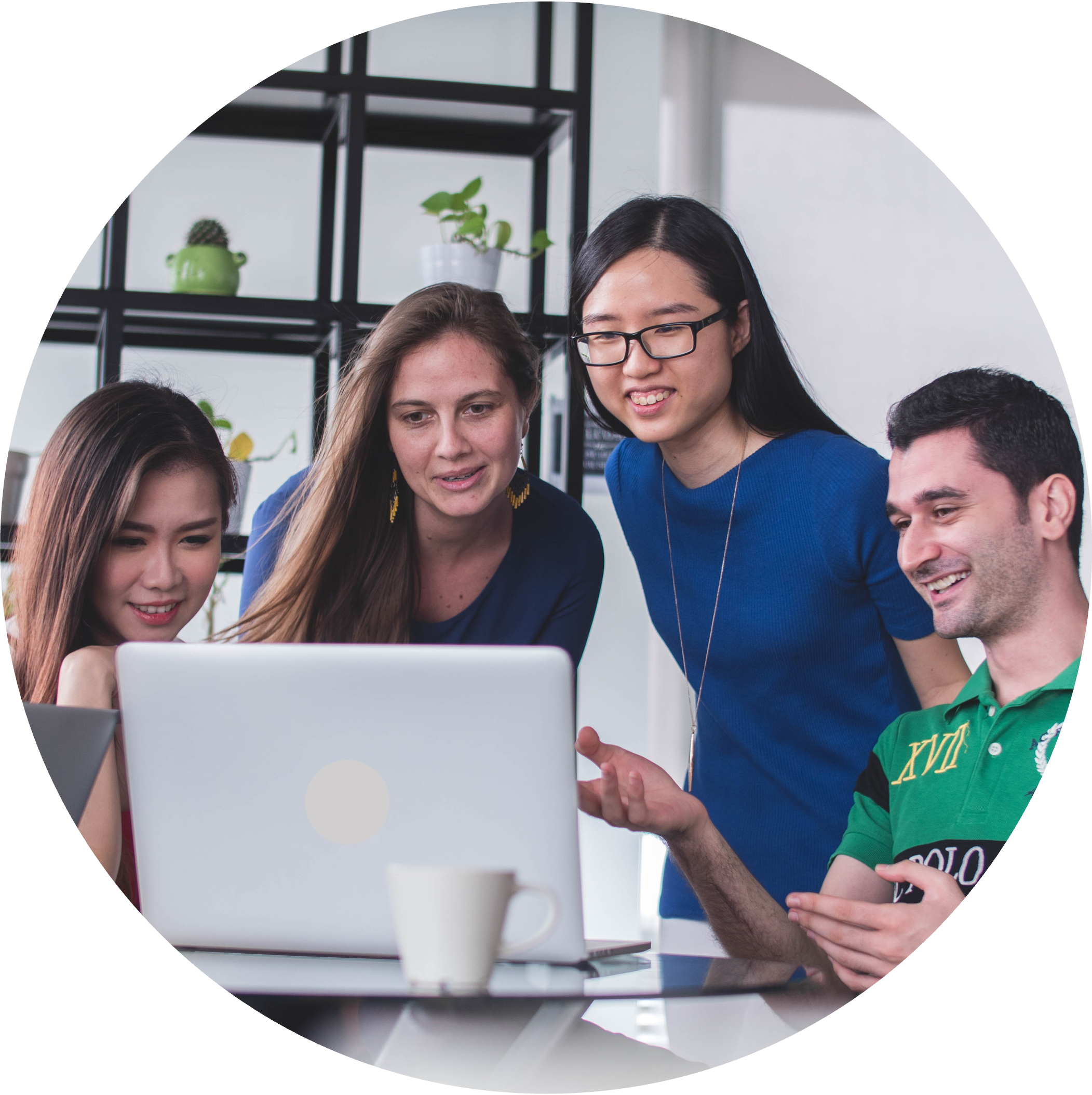 Four students in a group looking at a laptop