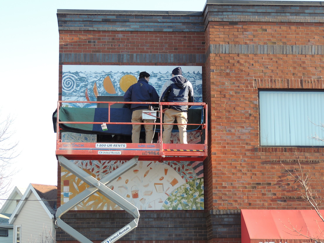 George Hagerty and Alfred Zuniga removing aluminum panels from Inman Square building