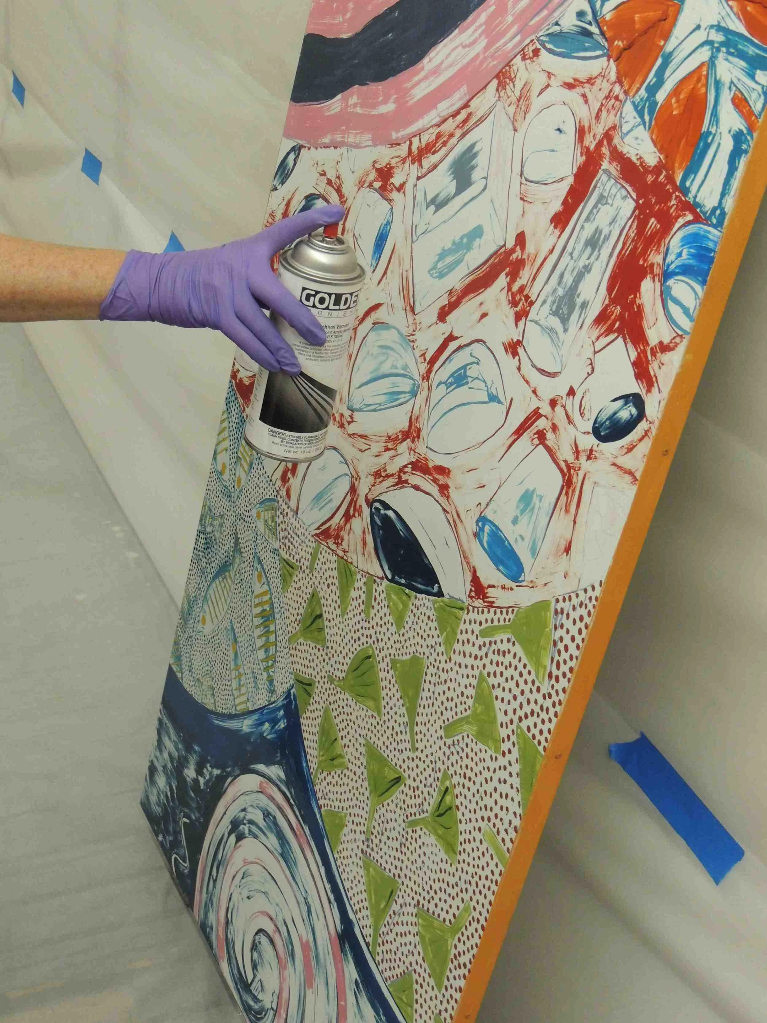 Rika Smith McNally and Regina Gaudette applied a layer of Golden MSA resin varnish to the surface to prepare it for painting with Golden acrylics.