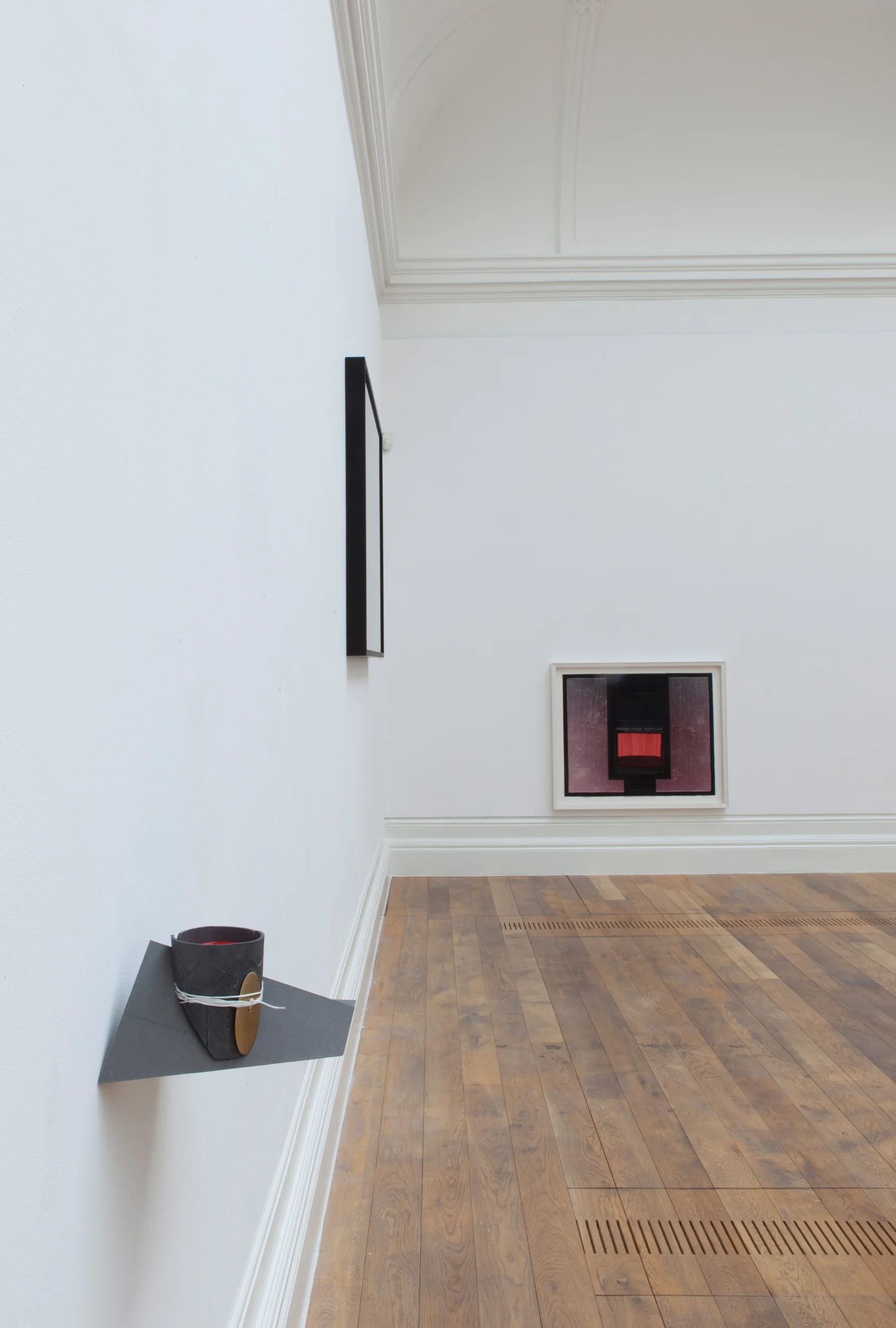 Installation view: Left: May (MacGuffin) , 2013 Graphite, resin, brass, string, red gloss enamel, giclée print 20 × 19 × 11 cm Background: Calendar , 2016 Paper, black carbon, giclée print 75.2 x 92.5 cm Photo credit: Dewi Lloyd.