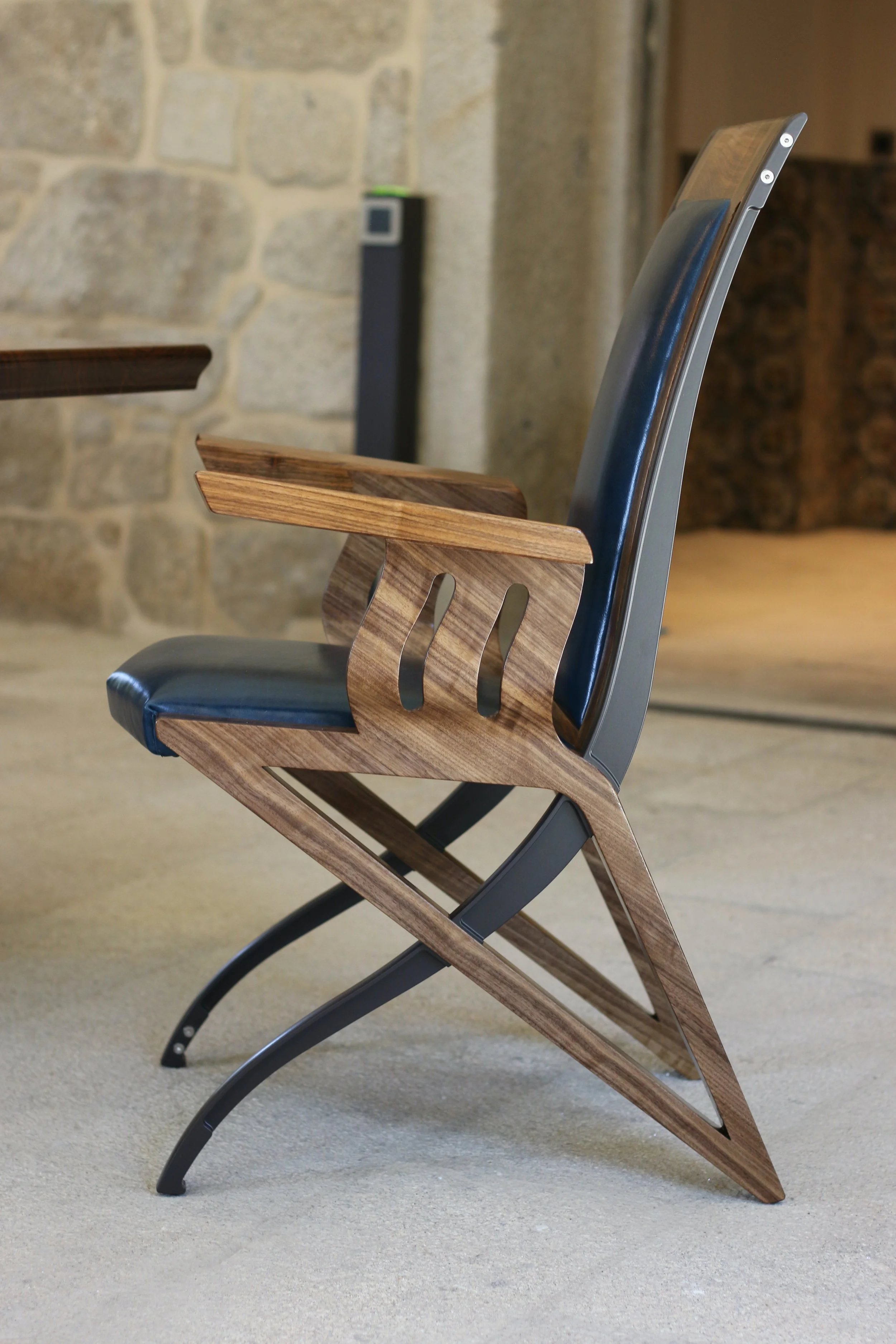 The Pegasus Chair. Upholstered in Blue leather and constructed in European Walnut and powder coated aluminium legs