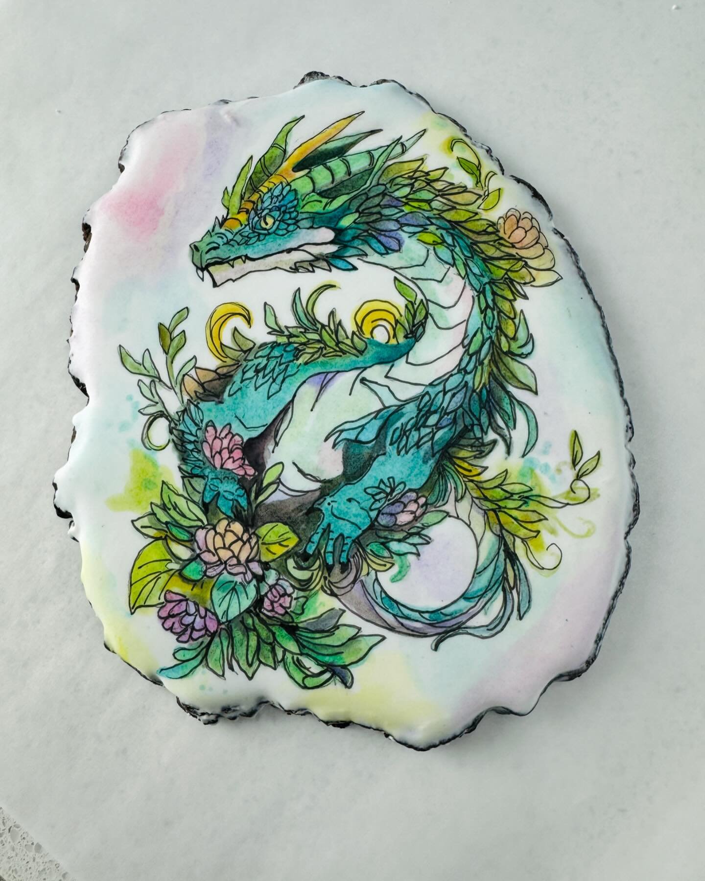 A whimsical Welsh dragon for @the_party_project Sally&rsquo;s surprise birthday party. 
.
#letssurprisesally
Hosted by 
Helene @holysugarbakeshop 
Danielle @bontecookies 
Edible paints by @rainbow_dust_colours on a chocolate 🍫 cherry 🍒 cookie. 
#ed