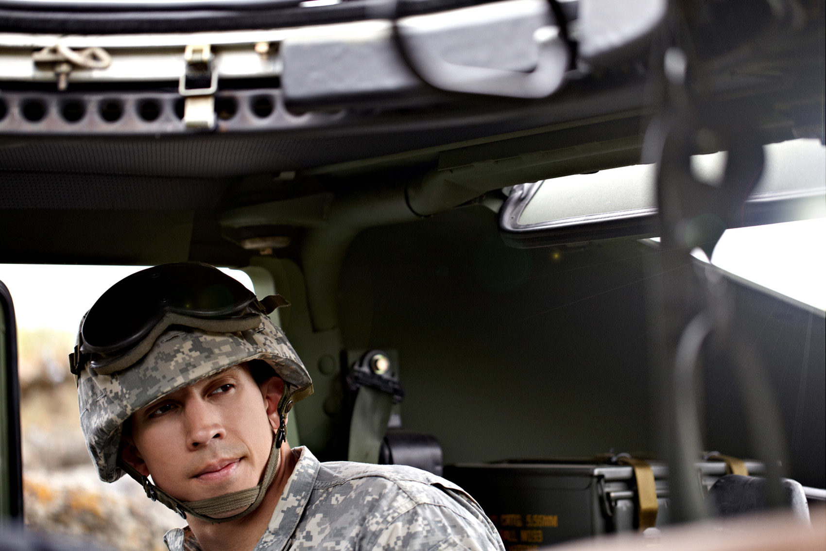 hispanic male soldier lifestyle inside of a hummer or humvee